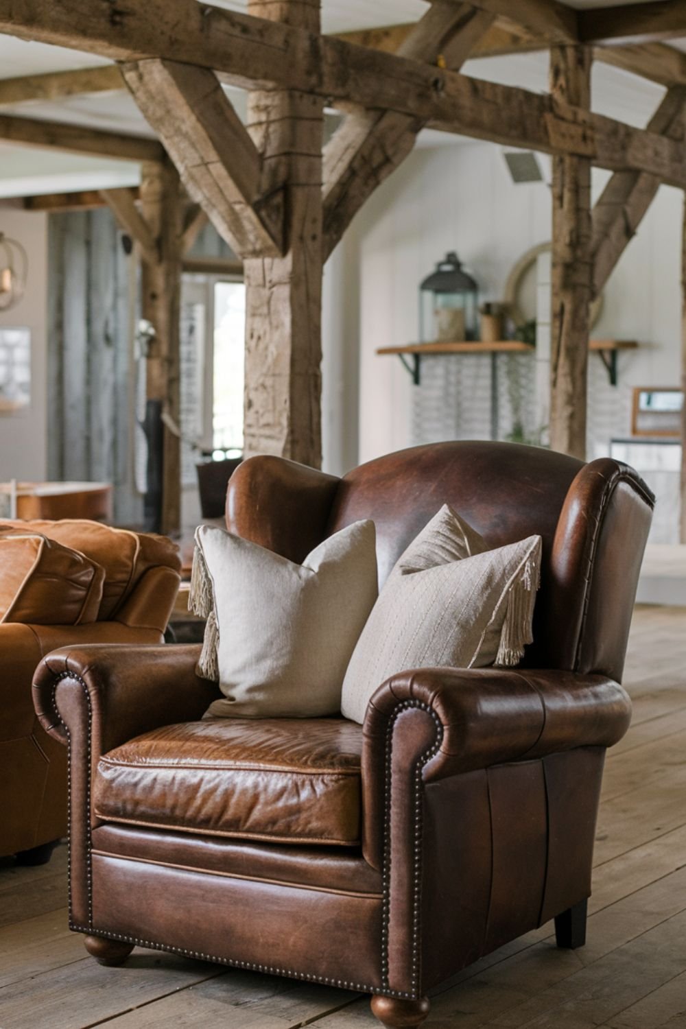 Cozy distressed leather armchair with warm brown tones, paired with a soft throw blanket.