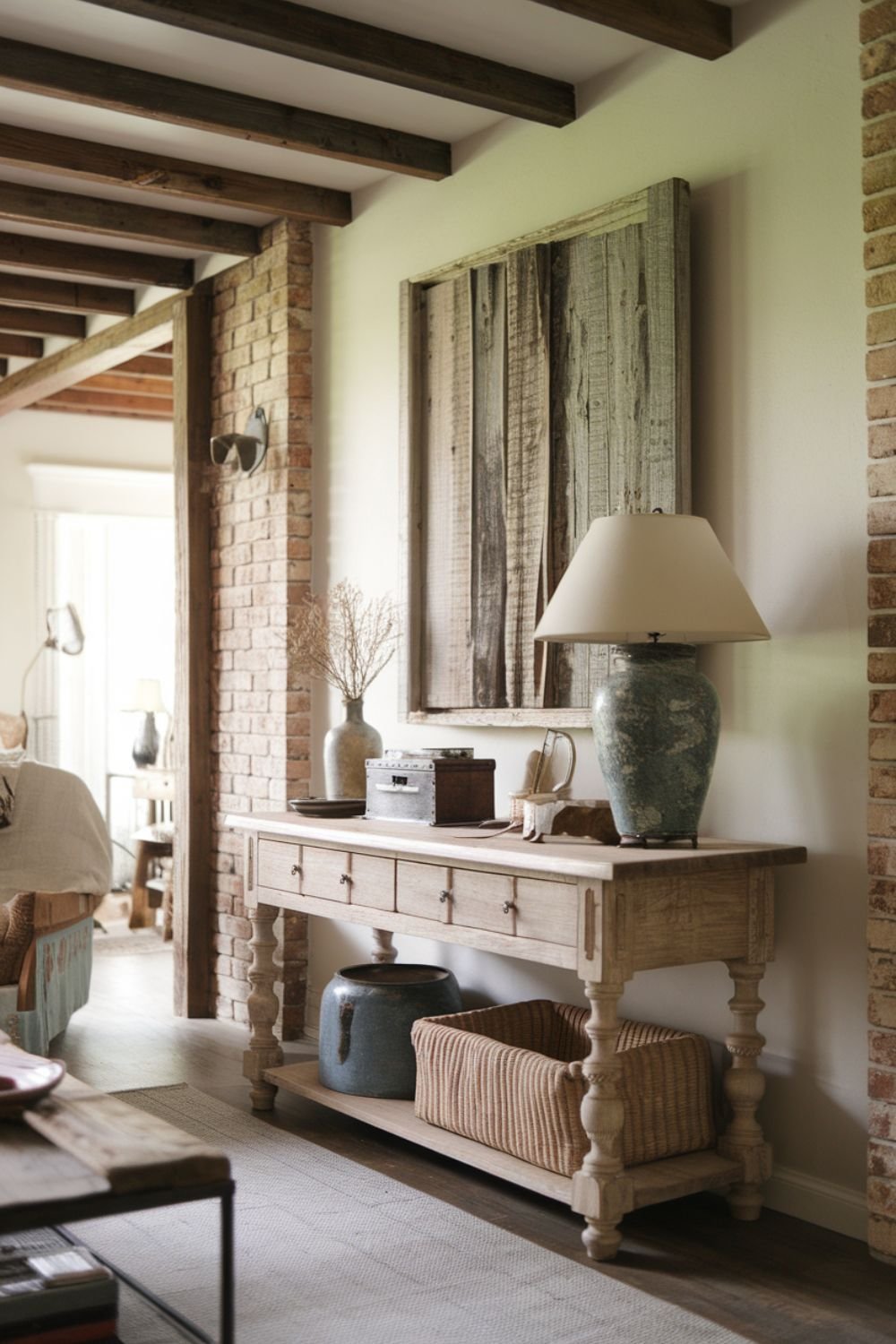 Weathered wood console table with a distressed finish, decorated with farmhouse accents.